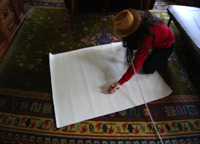Sam working on <em>4 Windows. Ballpoint on Canvas</em> installation